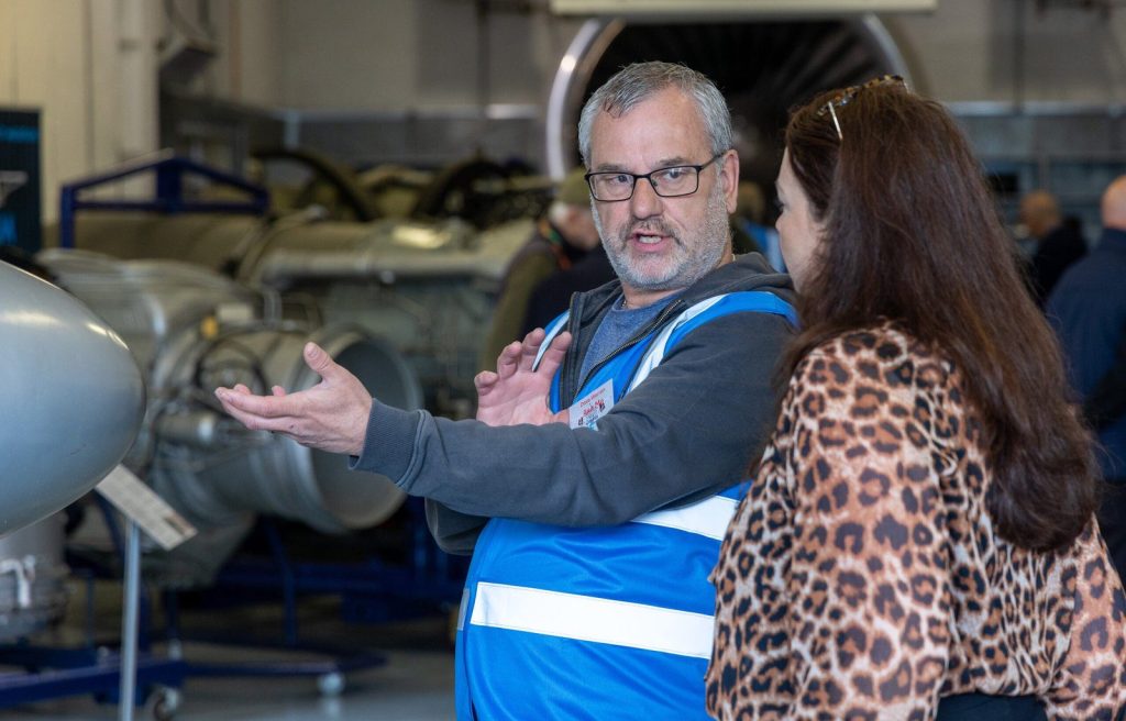 A volunteer guide showing visitors around